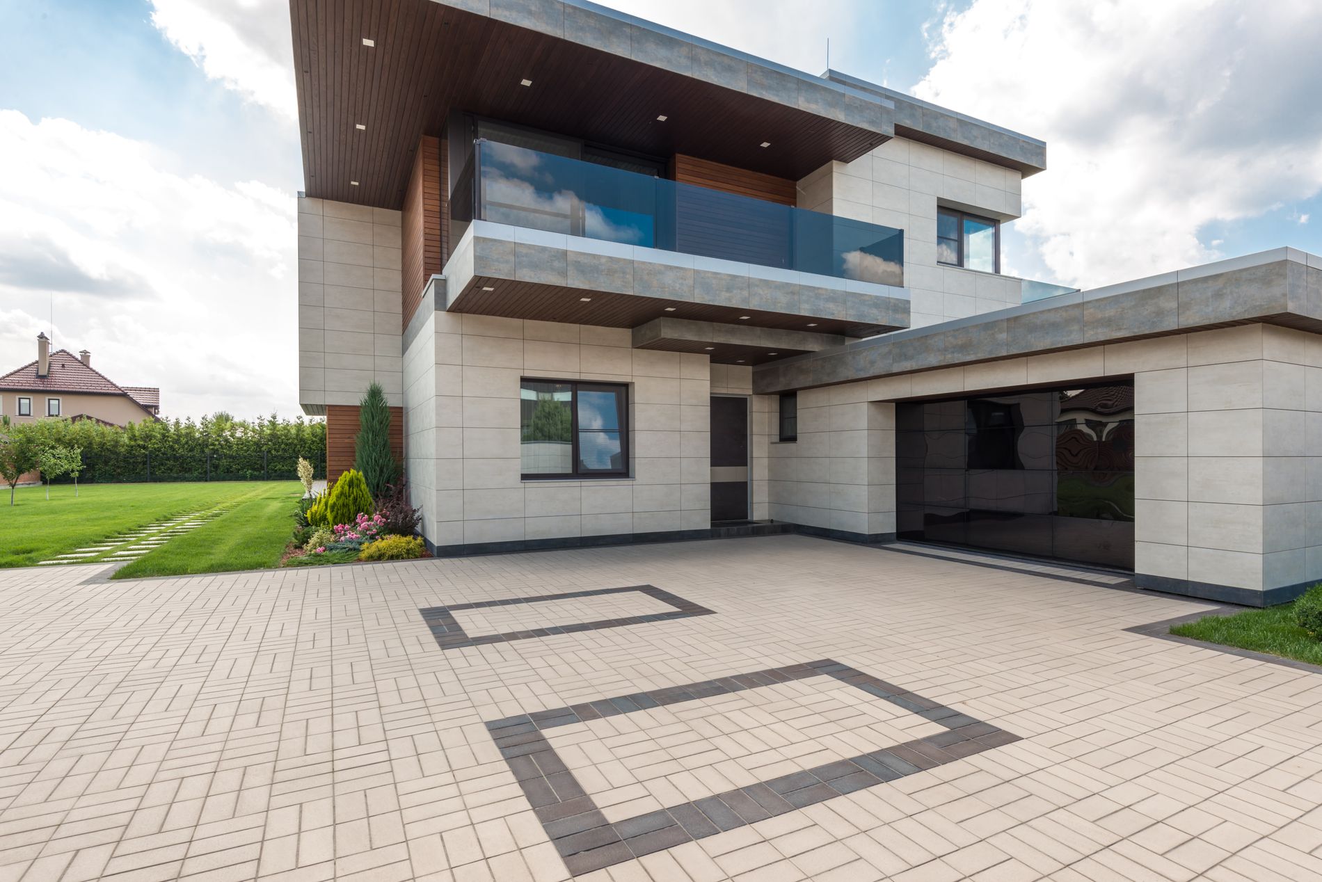 A bright modern home exterior with clean geometric lines under a blue sky